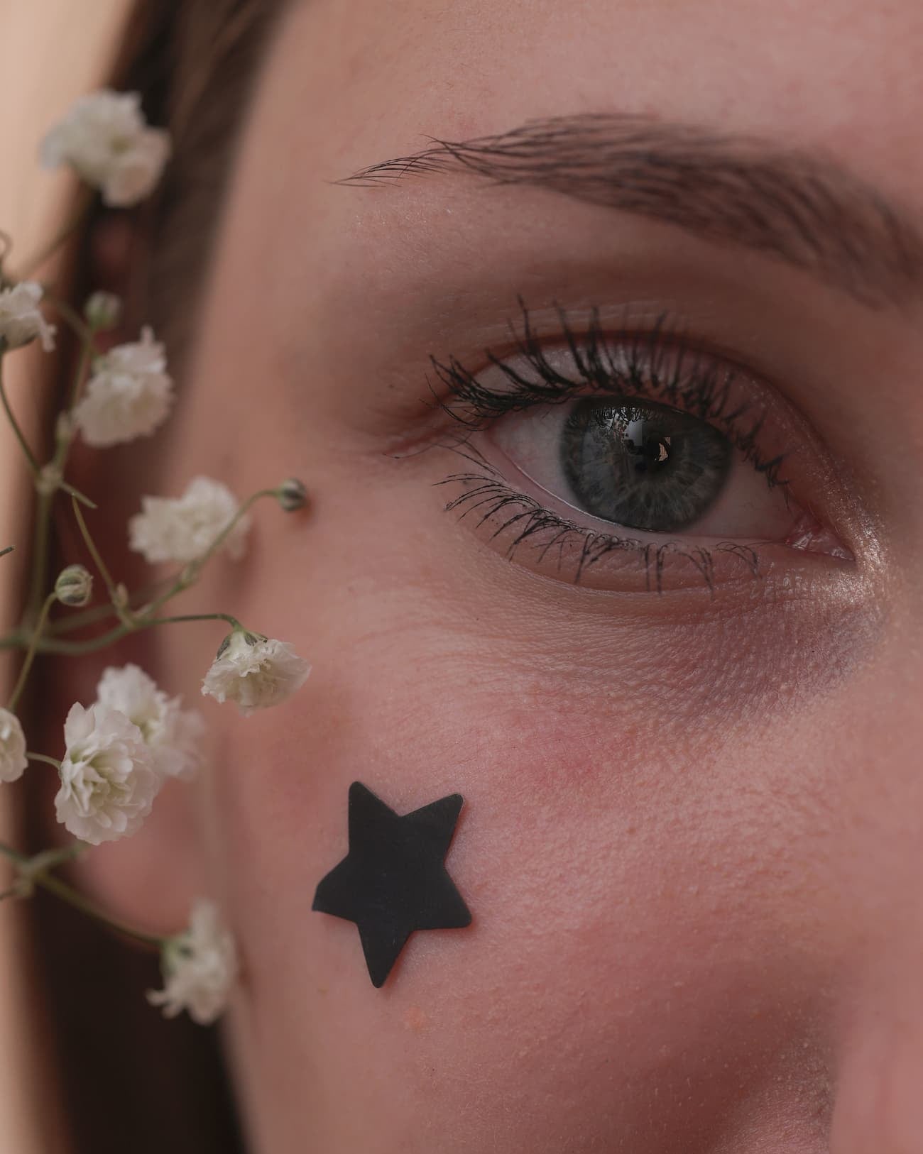 girl wearing pimple patch black star 